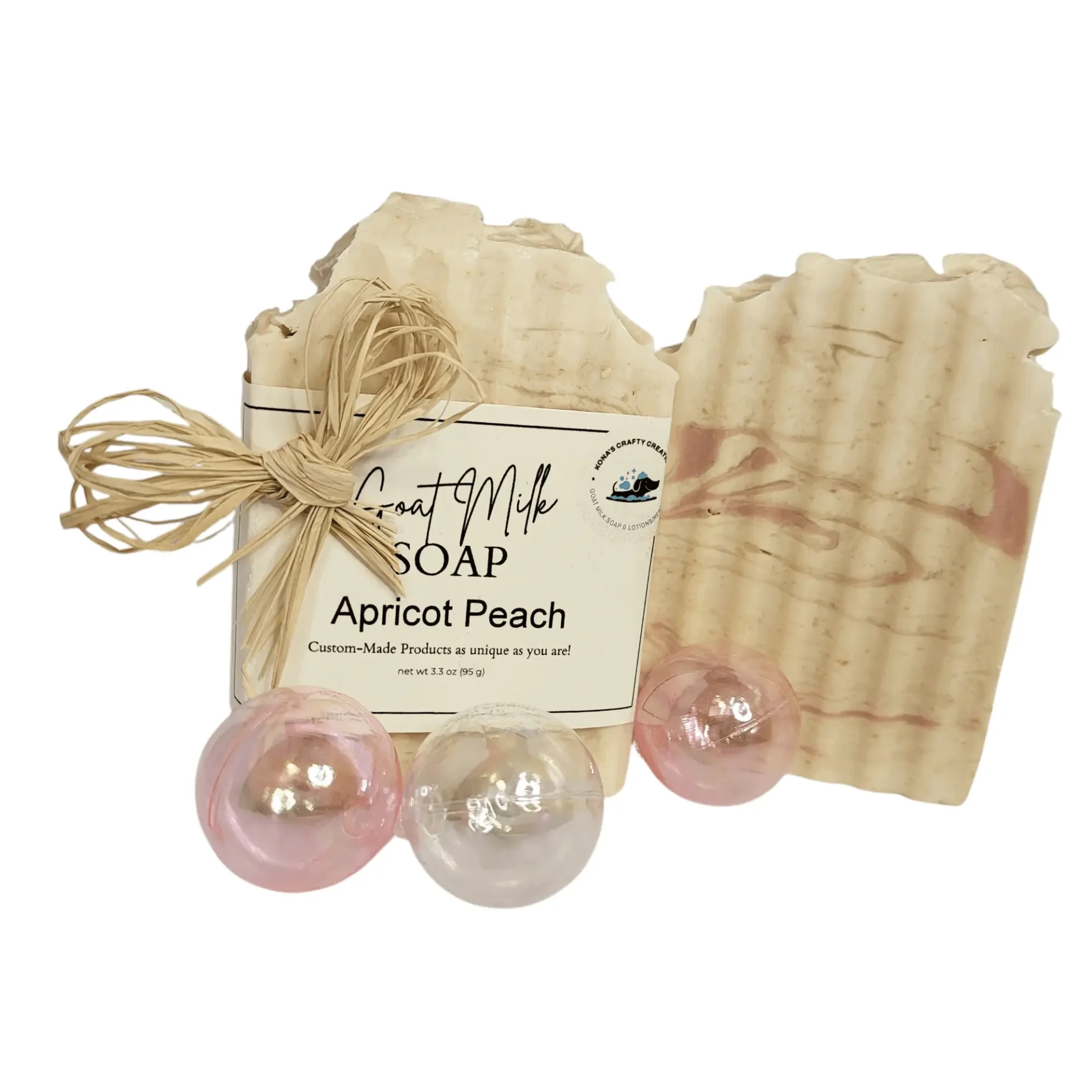 Goat milk soap with decorative pink spheres.