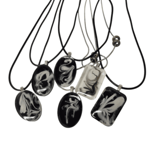 Black and white marbled pendants on cords.