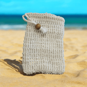 White crochet bag on sandy beach.